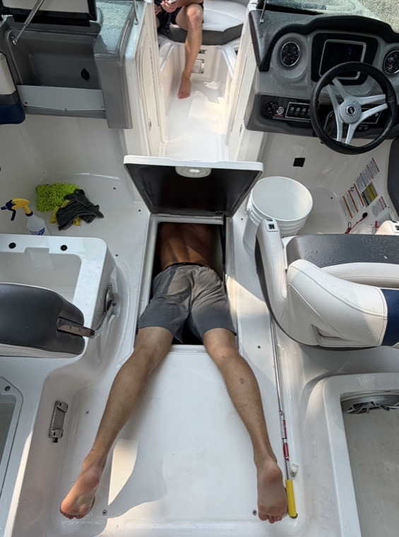 Reaching into a storage hatch to clean every compartment