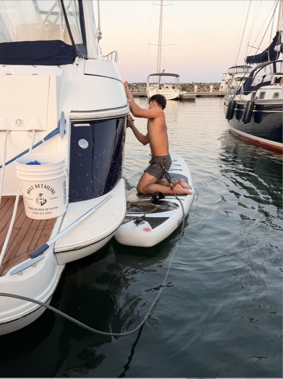 Washing a hull from the water at a Chicago harbor at dusk